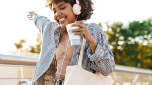 3 Little-Known Ways to Stop Binge Eating and Regulate Distressful Emotions without Food-BIPOC woman happy holding a coffee